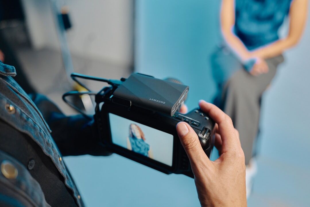 Camera operator filming a presenter rehearsing in front of a lens